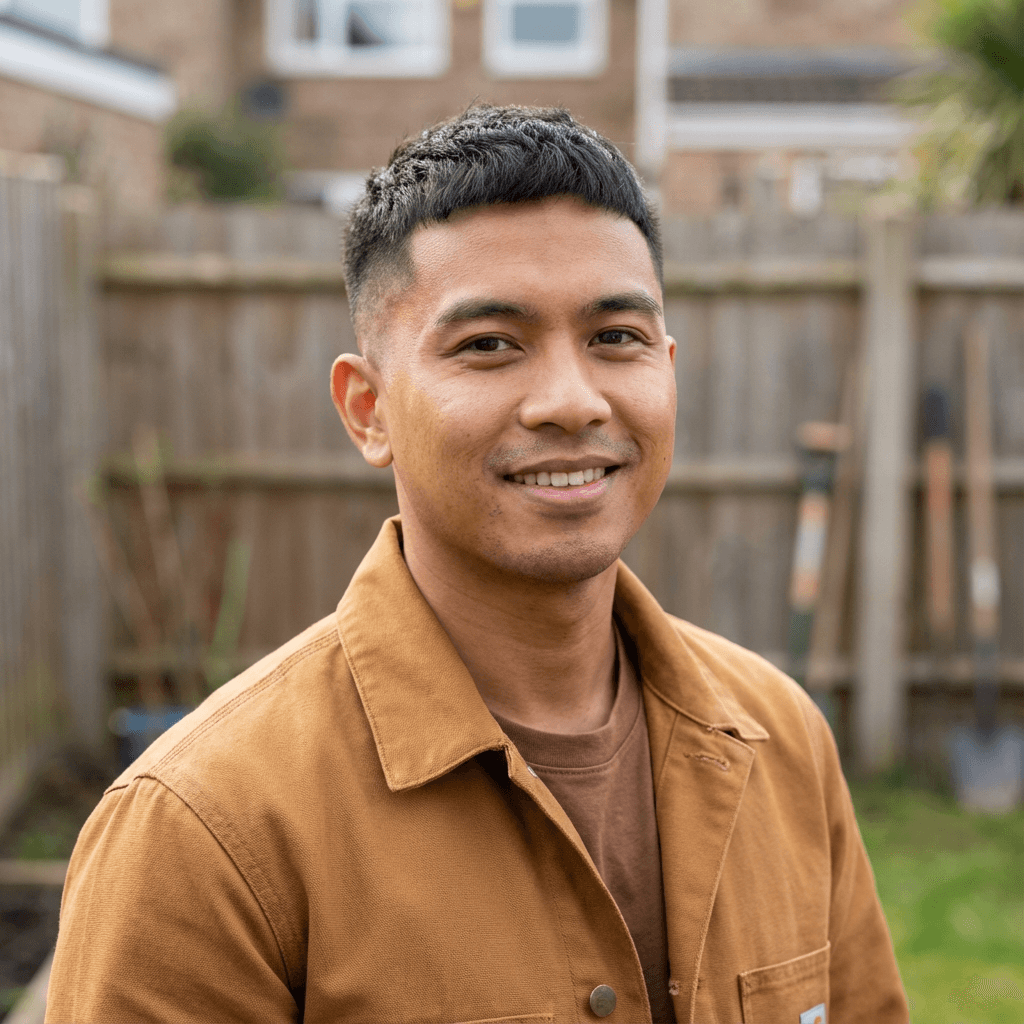 Daniel Morrison in casual attire smiling at his front door